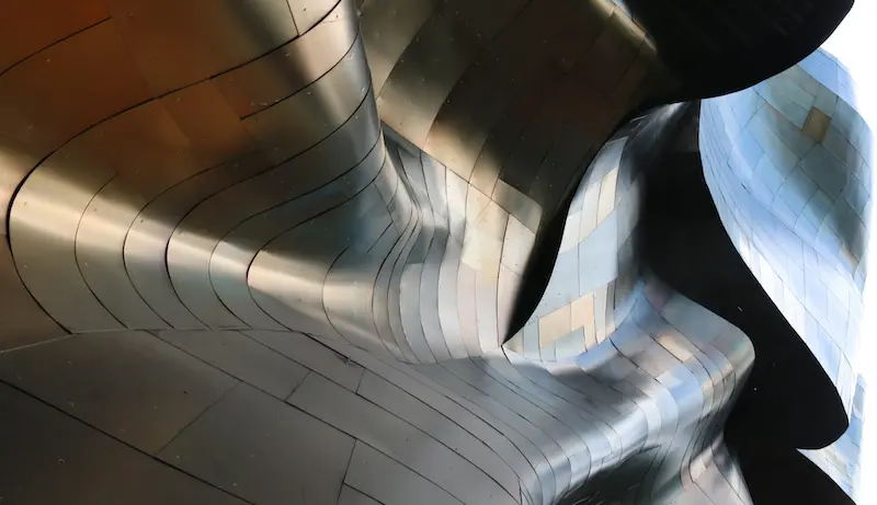 The curved surface of the facade of the Museum of Pop Culture in Seattle.