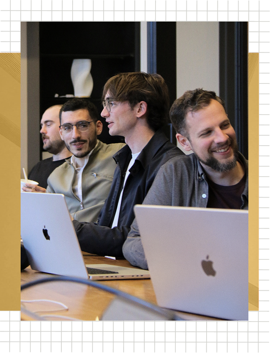 Goodfire team members working together on laptops around a table
